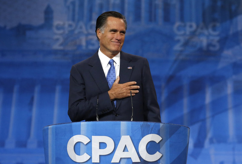 Former presidential candidate Mitt Romney puts his hand to his heart as supporters cheer him upon taking the stage at the Conservative Political Action Conference on Friday.