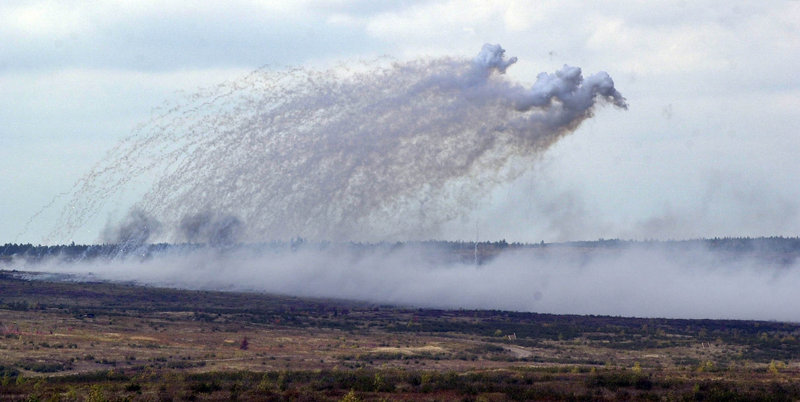 Smoke hovers over a field where artillery shells just hit at Canadian Forces Base Gagetown in New Brunswick, Canada, in October 2001.