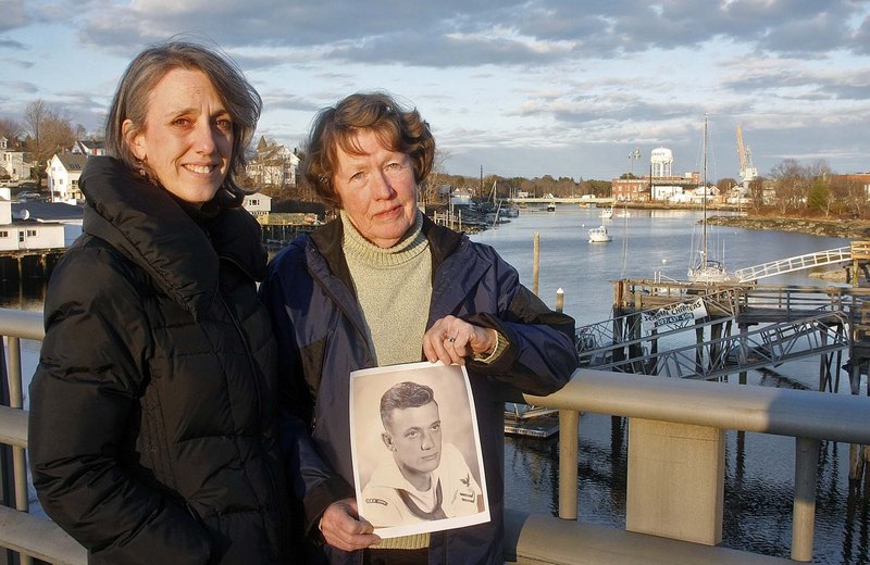 Debby Ronnquist, right, and her daughter, Marcye Philbrook, show a portrait of Ronnquist's former husband and Philbrook's father, Julius Francis Marullo, who died on the USS Thresher.