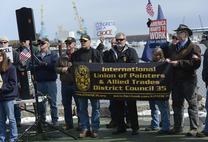 Shipyard workers gather at Prescott Park in Portsmouth, N.H., across the river from the Kittery naval yard, on Thursday to protest the expected shrinking of their paychecks.