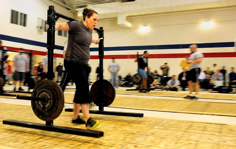 Nicole Turbide, of Bangor, competes in the yoke walk during the 2013 Central Maine Strongman contest on Saturday at the Augusta armory.