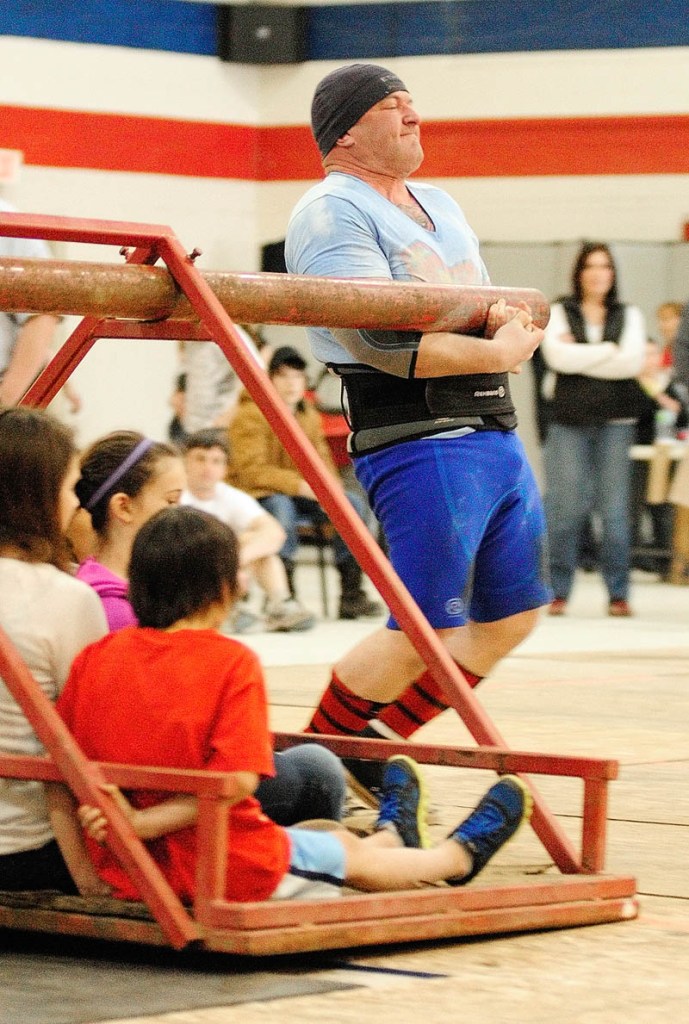 Rob Drummond, of Augusta, stops in exhaustion after carrying several children around a pivot in the Conan's wheel event, during the 2013 Central Maine Strongman contest on Saturday at the Augusta armory.