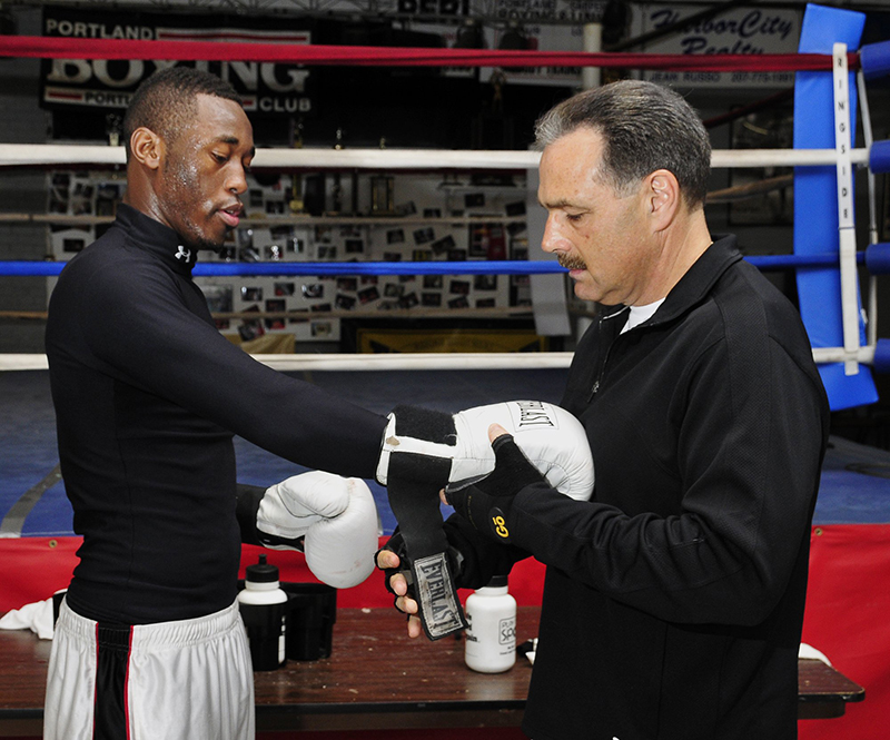 In this April 29, 2008 file photo, Russell Lamour gets help from coach Bobby Russo at the Portland Boxing Club. A week after this photo was taken, Lamour competed in the National Golden Gloves Championship in Utah, where now-dead Boston Marathon bombing suspect Tamerlan Tsarnaev was also a competitor.