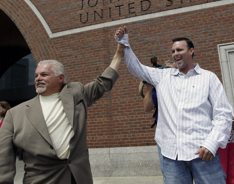 Steve Davis, left, and Tommy Donahue clasp hands as they react outside federal court in Boston on June 12, 2012, after Catherine Greig, who spent 16 years on the run with former Boston mobster James "Whitey" Bulger, was sentenced to eight years in prison for helping to hide one of the FBI's Ten Most Wanted Fugitives. Davis and Donahue are family members of victims.