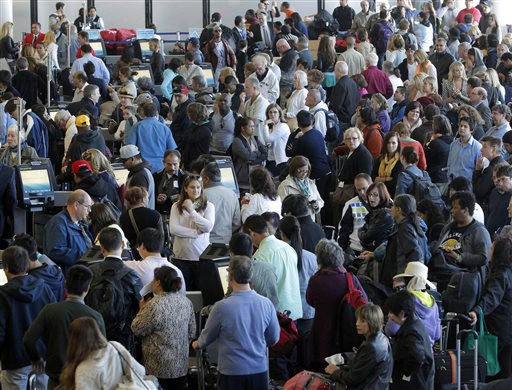 Passengers gather at the American Airlines check-in for flights at Los Angeles International Airport on Tuesday. Computer problems forced American Airlines to ground flights across the country after the airline was unable to check passengers in and book passengers.