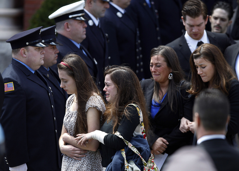Mourners leave the funeral for Boston Marathon bombing victim Krystle Campbell, 29, at St. Joseph's Church in Medford, Mass., on Monday.