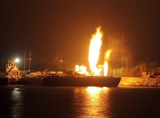 Fire burns aboard two fuel barges along the Mobile River after explosions sent three workers to the hospital on Wednesday. Fire officials pulled units back from fighting the fire due to the explosions and no immediate threat to lives.