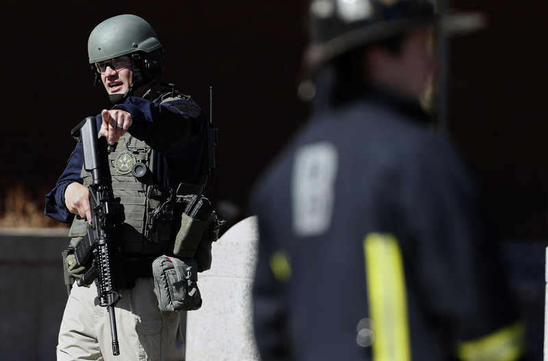 A heavily armed United States Marshall stands guard outside the Moakley Federal Court House in Boston after the building was evacuated, Wednesday, April 17, 2013. (AP Photo/Michael Dwyer)