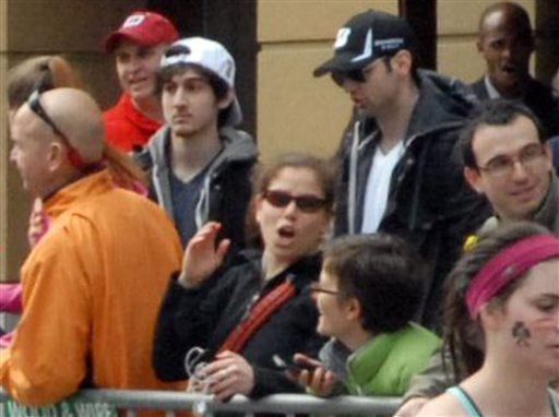 This April 15, 2013, photo provided by Bob Leonard shows bombing suspects Tamerlan Tsarnaev, 26, in black hat, and his brother, Dzhokhar A. Tsarnaev, 19, in white hat, approximately 10-20 minutes before the blasts that struck the Boston Marathon. Some experts in sibling research say the powerful bonds that can develop between brothers may have played a role in the bombings.