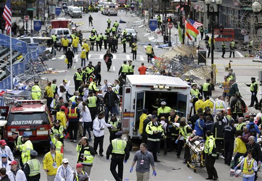 Medical workers aid injured people at the finish line of the 2013 Boston Marathon following an explosion in Boston on Monday, Two explosions shattered the euphoria of the Boston Marathon finish line, sending authorities out on the course to carry off the injured while the stragglers were rerouted away from the smoking site of the blasts.
