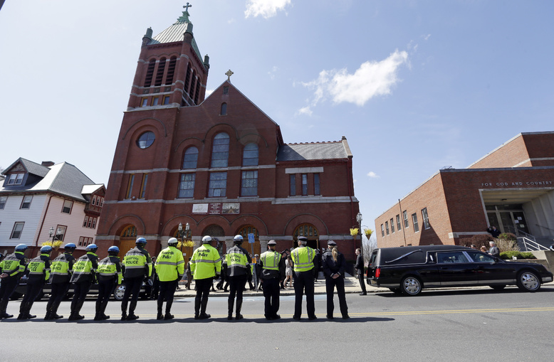 Medford and Somerville police line the street outside St. Joseph's Church in Medford, Mass., on Monday for the funeral of Boston Marathon bomb victim Krystle Campbell, 29.