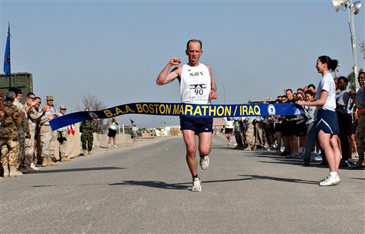 FILE - In this April 15, 2006 file photo released by the U.S. Air Force, Navy Lt. Cmdr. Matt Simms crosses the finish line to win the 2nd Annual Boston Marathon/Iraq in Ali Base, Talil, Iraq. Lt. Col. Rodney Freeman is being honored by the Boston Athletic Association prior to the April 2013 Boston Marathon, with its Patriots Award for his work in establishing the "shadow marathon" at his military base in Iraq. (AP Photo/Master Sgt. Jon Hanson, U.S. Air Force, File)