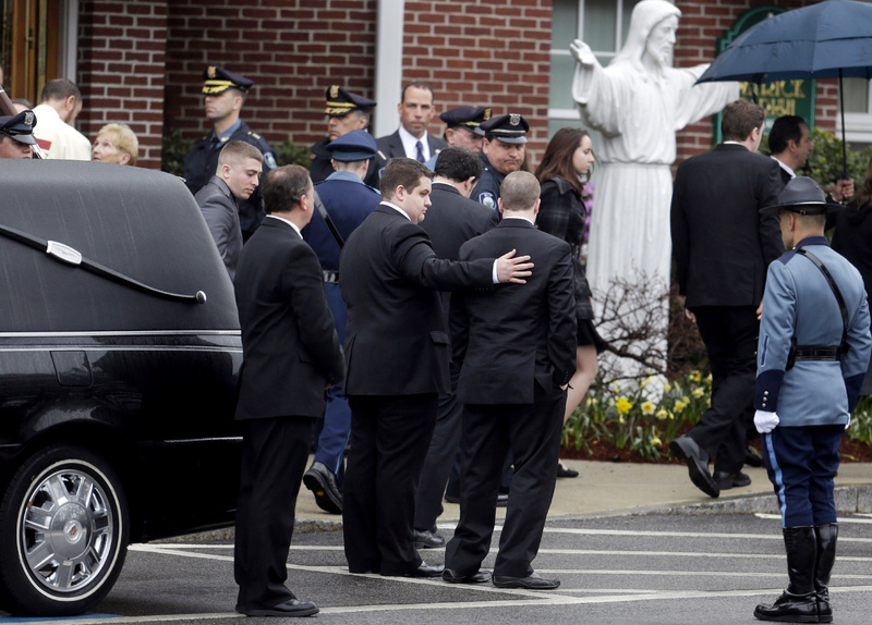 Mourners depart St. Patrick's Church in Stoneham, Mass., following a private funeral Mass for Massachusetts Institute of Technology police officer Sean Collier on Tuesday. A memorial service will be held Wednesday.