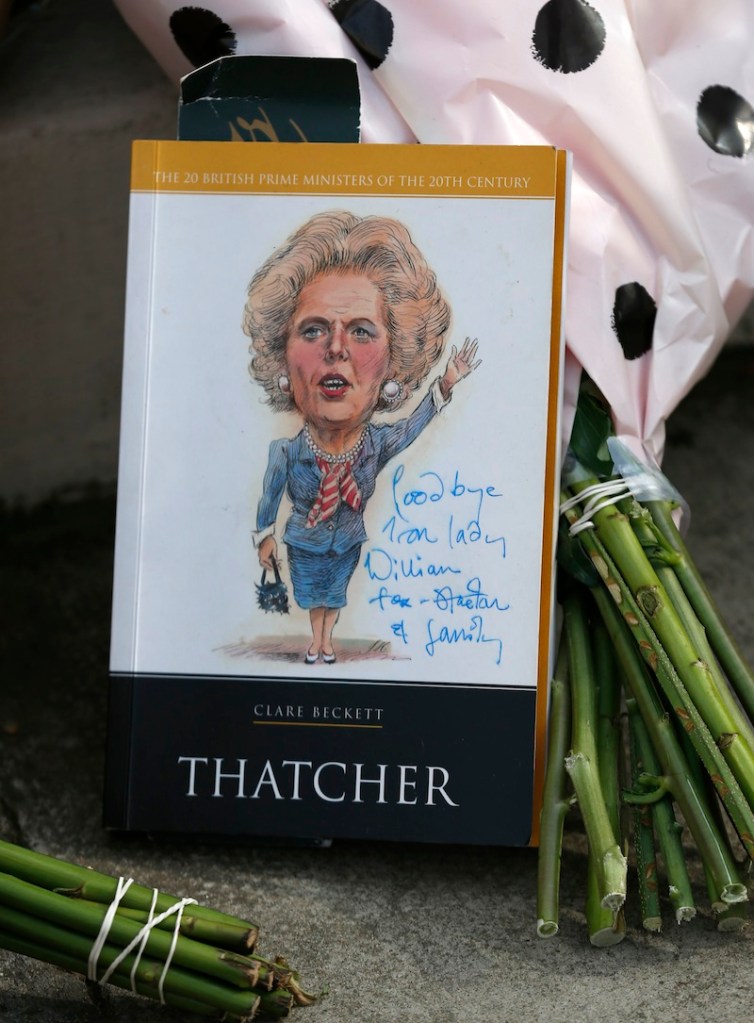 Floral tributes and memorabilia are seen outside the house of former British Prime Minister Margaret Thatcher who died from a stroke at the age of 87, London, Monday, April 8, 2013. (AP Photo/Sang Tan)