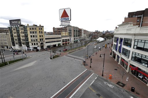 CORRECTS DATE TO APRIL 19, NOT 18 - The usually busy Kenmore Square in Boston is virtually deserted at lunchtime Friday, April 19, 2013, during a call for "shelter-in-place" for Boston and some area communities. Two suspects in the Boston Marathon bombing killed an MIT police officer, injured a transit officer in a firefight and threw explosive devices at police during their getaway attempt in a long night of violence that left one of them dead and another still at large Friday, authorities said as the manhunt intensified for a young man described as a dangerous terrorist. (AP Photo/Elise Amendola) BOSTON MARATHON EXPLOSIONS