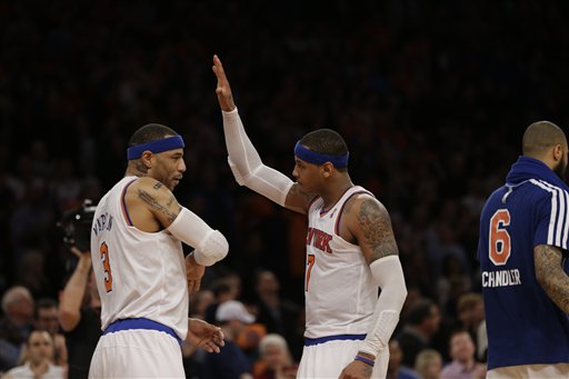 New York Knicks forward Kenyon Martin, left, and New York Knicks forward Carmelo Anthony celebrate near the end of the Knicks 85-78 victory over the Boston Celtics in the second half of Game 1 of the NBA basketball playoffs in New York, Saturday, April 20, 2013. (AP Photo/Kathy Willens)