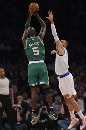 New York Knicks center Tyson Chandler (6) defends as Boston Celtics center Kevin Garnett (5) shoots in the first half of Game 2 of their first-round NBA basketball playoff series in New York, Tuesday, April 23, 2013. (AP Photo/Kathy Willens)