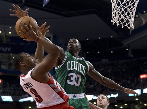 Toronto Raptors guard Kyle Lowry (3) tries to shoot under pressure from Boston Celtics forward Brandon Bass (30) during first-half NBA basketball game action in Toronto, Wednesday April 17, 2013. (AP photo/The Canadian Press, Frank Gunn) basketball;Raptors;Association;athlete;athletes;athletic;athletics;Canada;Canadian;competative;compete;competing;competition;competitions;court;entertainment;event;game;league;National;NBA;player;players;pro;professional;sport;sporting;sports;Toronto