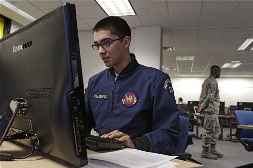 A cadet works at a large computer display in a classroom at the Center for Cyberspace Research at the U.S. Air Force Academy in Colorado Springs, Colo.