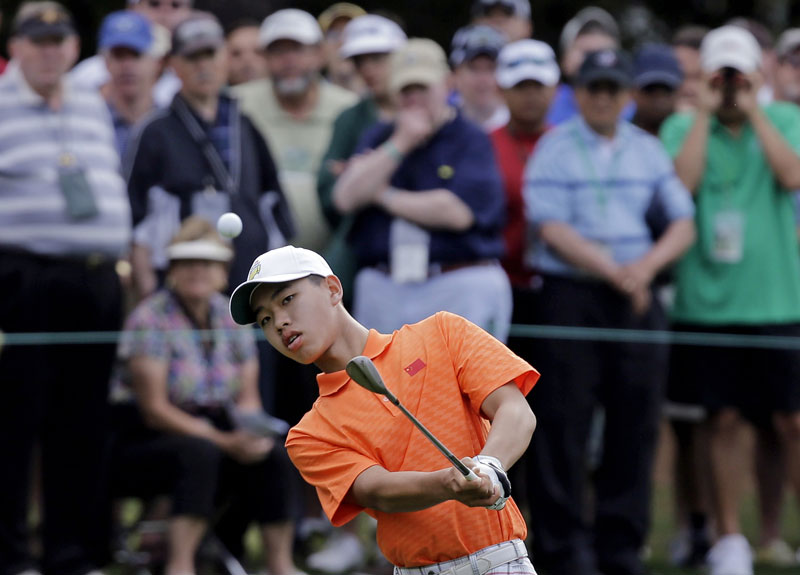 Amateur Guan Tianlang, of China, chips to the first green during the second round of the Masters golf tournament Friday, April 12, 2013, in Augusta, Ga. (AP Photo/David J. Phillip)
