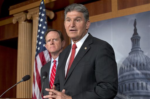 Sen. Joe Manchin, D-W.Va., right, accompanied by Sen. Patrick Toomey, R-Pa., announce that they have reached a bipartisan deal on expanding background checks to more gun buyers.