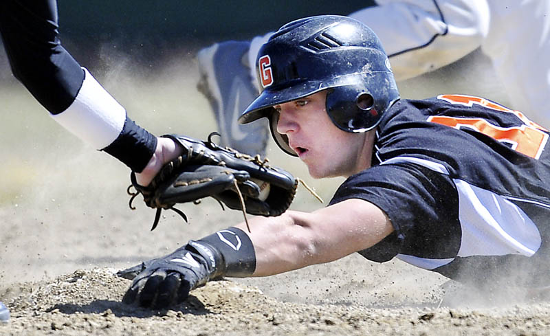 GOING LOW: Gardiner Area High School's Frank Chepke slides into second base under a tag by Lincoln Academy's Chris Gove during the Tigers’ 11-1 Wednesday in Gardiner.