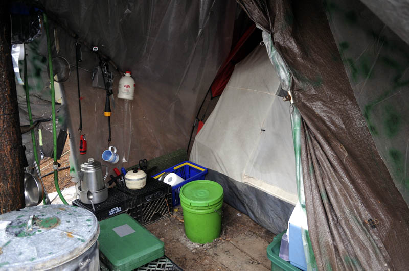 Christopher Knight's camp on Tuesday in a remote, wooded section of Rome. Knight kept camping supplies and a tent beneath a brown tarp where he lived, police say.