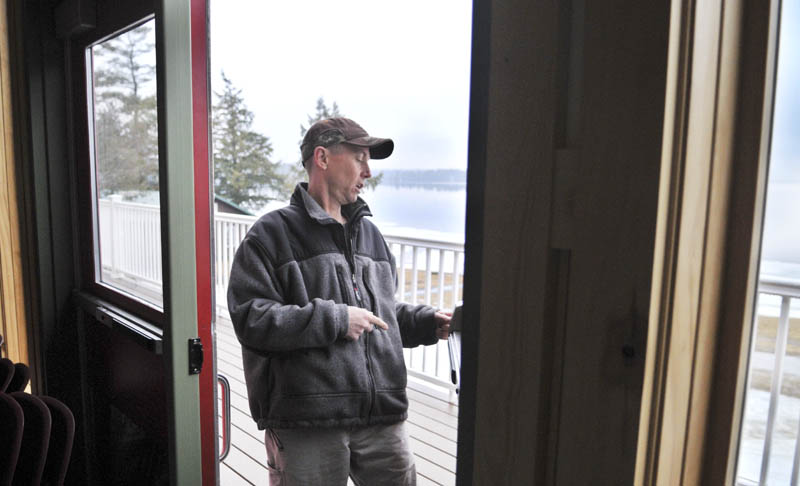 Pine Tree Camp facility manager Harvey Chesley inspects a door that Christopher Knight alleged broke open in the dining lodge at the Rome camp, on Tuesday. Knight, a hermit who lived in the woods since April 1986, was arrested in after allegedly breaking into the lodge on Thursday, according to Warden Service Sgt. Terry Hughes.