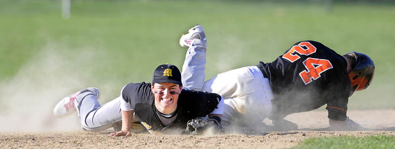 LOOK OUT: Winslow High School’s Dylan Hapworth, right, slides into Maranacook Community School’s Tucker Whitman at second base Tuesday in Readfield. Hapworth made it safely to the base. The Black Raiders won 12-5.