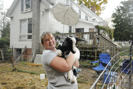 Marcina Johnston, seen last October, has been raising goats with her family in the backyard of their Gardiner home, even though it's in defiance of a city ordinance. Johnson had hoped to change the ordinance to permit small farm animals within such urban areas, but city councilors have not acted on a proposal allowing small livestock within the urban area.