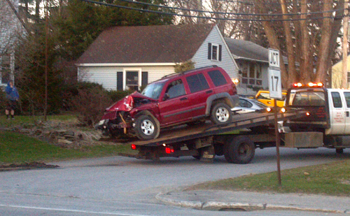 A 2005 Jeep Liberty is taken away from a tow truck Wednesday night in Augusta after police charged the driver, Megan Moone, of Mount Vernon, with drunken driving. The SUV crashed near state police barracks on Hospital Street and hit two utility poles, police said.