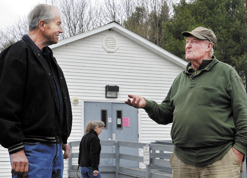 Pittston Selectman Chair Ted Sparrow Jr, right, confers with resident Darrell Weymouth on Wednesday outside the town hall where a special election was being held to determine if Sparrow should be recalled and to elect a new selectman to replace Tim Marks, who resigned from the board in March.