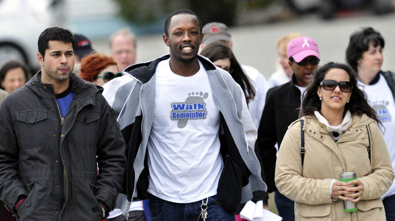 Sahil Sanan, left, and Judith Rodriguez accompany Eric Habineza, center, a Rwandan national, during the Walk to Remember on Tuesday in Augusta, to recall the 1994 genocide in Rwanda. The event, sponsored by the Holocaust Human Rights Center of Maine, commemorates the slaughter of a nearly a million residents of the African country.