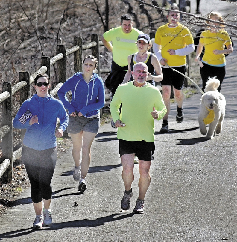 Runners and walkers head down the Kennebec Rail Trail in Hallowell Wednesday to show solidarity with people injured in the blasts at the Boston Marathon on Monday. About two dozen people made a trip to Augusta and back.