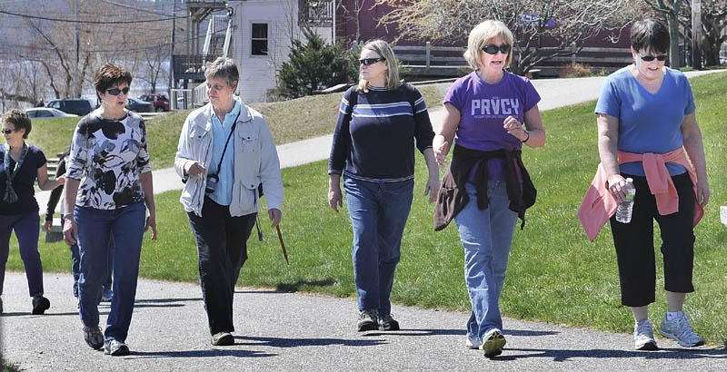 Members of the Maine International Adventure Club walk up the Kennebec River Rail Trail Sunday in Hallowell. The Club is planning a trip to Ireland.
