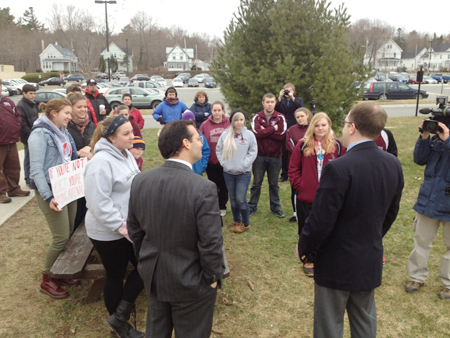 Democrats Rep. Seth Berry, left, and Sen. Seth Goodall meet with students protesting education budget cuts this morning at the State House in Augusta