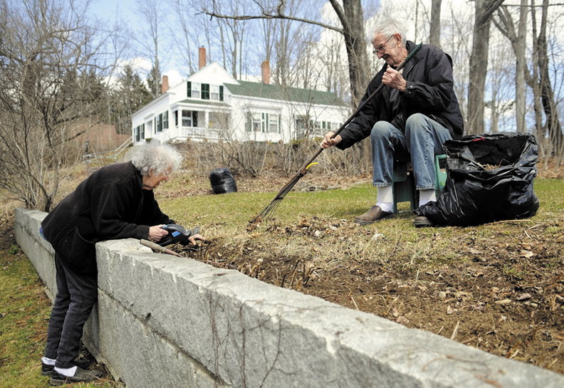 Polly Peters Blake, 85, and her husband, Bear, 76, clean up the peonies bed Monday outside their Mount Vernon farm. The couple relocated to the town three years ago, Polly said, but she recalls watching a previous owner of the farm plant the bed "over 40 years ago."