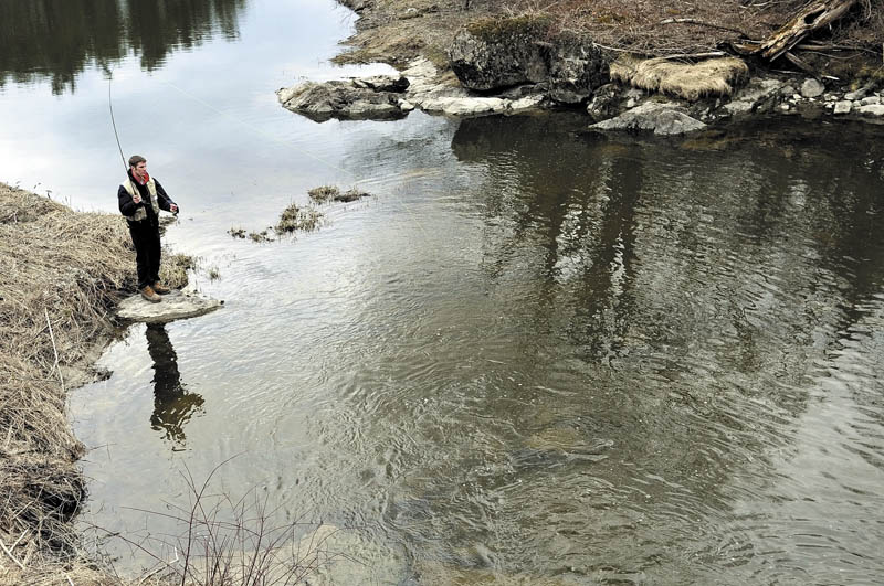 Wyatt Rush, 18, of Farmingdale, casts a nymph Thursday in a Hallowell stream while learning to fly fish as part of his senior project at Hall-Dale High School. Rush said he had to study the history of fishing, the science of tying flies and practice casting with the hope of catching a few trout. "I'm still pretty new to this," Rush said while roll casting his line.