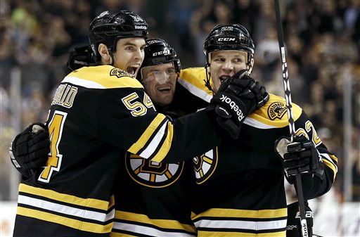 Boston Bruins' Daniel Paille, center, celebrates his goal with Shawn Thornton, right, and Adam McQuaid during the second period of a NHL hockey game against the Tampa Bay Lightning in Boston, Thursday, April 25, 2013. (AP Photo/Winslow Townson)