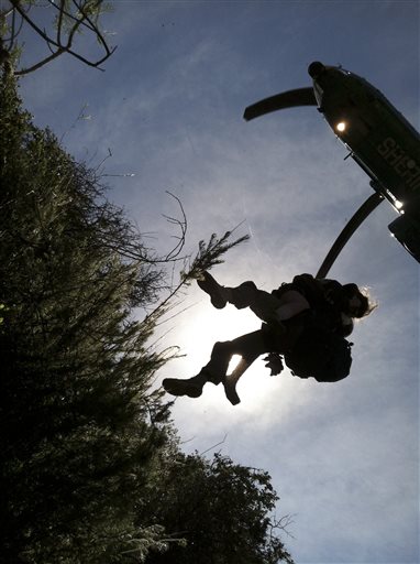 This photo provided by Los Angeles County Search and Rescue Reserve Deputy Doug Cramoline shows the helicopter rescue of Kyndall Jack, 18, by an L.A. County deputy after being missing for five days in rugged country near Rancho Santa Margarita, Calif.