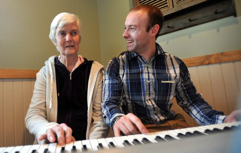 Scott McManaman, director at Bedside Manor, plays a duet of "Chopsticks" with resident Martha Fabian at Bedside Manor on Belgrade Road in Oakland on Wednesday.