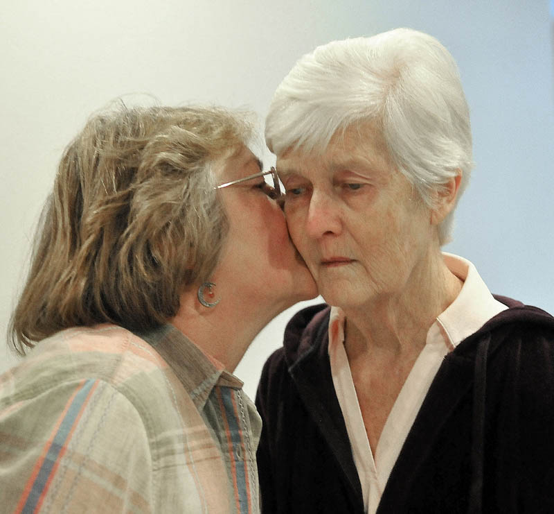 Christine Pillsbury, left, gives her friend, Martha Fabian, a kiss on the cheek after a visit at Bedside Manor on Belgrade Road in Oakland on Wednesday.