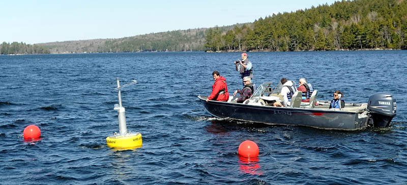 Colby College and Belgrade Regional Conservation Alliance researchers float past the research buoy named Goldie on Great Pond in Belgrade Thursday. The research buoy can be accessed online to inspect data it collects.