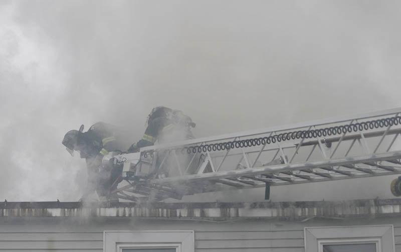 Firefighters from Waterville, Winslow and Fairfield battle a fire at 10 Maple St. in Fairfield on Tuesday.