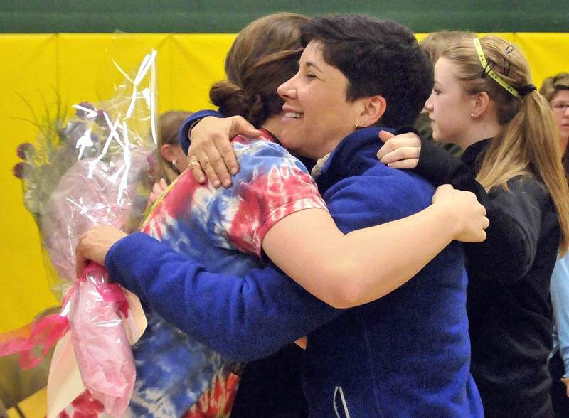 Marisa Weinstein, music teacher at Warsaw Middle School, hugs students after she was presented with the Maine Music Educators Association Educator of the Year award during a surprise assembly at the school on Tuesday.