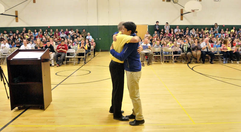 Marisa Weinstein, music teacher at Warsaw Middle School in Pittsfield, receives a hug after she was presented the Maine Music Educators Association Educator of the Year award at the school on Tuesday.