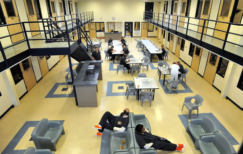 Inmates read and play board games in the day room in the medium security wing at the Somerset County Jail in East Madison on Tuesday.