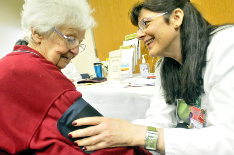 Dorothy Dostie, 91, of Waterville, has her blood pressure checked by Hope Pendexter, a registered nurse at Inland Hospital, at the 16th annual Word of Women's Wellness event, sponsored by Inland Hospital, at Thomas College on Saturday.