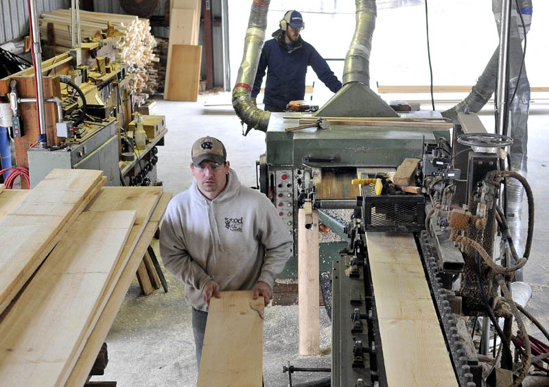 Nate Lesperance, 31, left, and Josh Saltmarsh, 24, back, plain wood at The Wood Mill of Maine on Mercer Road in Mercer on Friday.