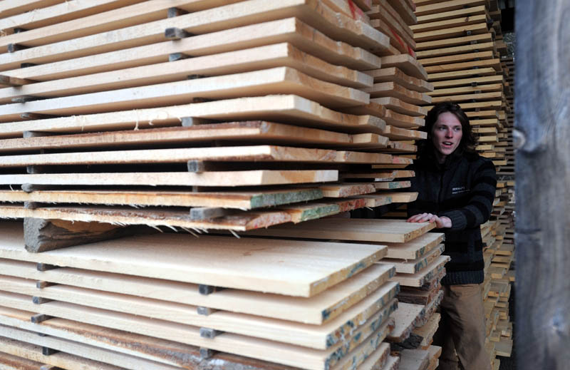 Bjarki Gunnarson, 25, inspects a stack of finished lumber at The Wood Mill of Maine on Mercer Road in Mercer on Friday.